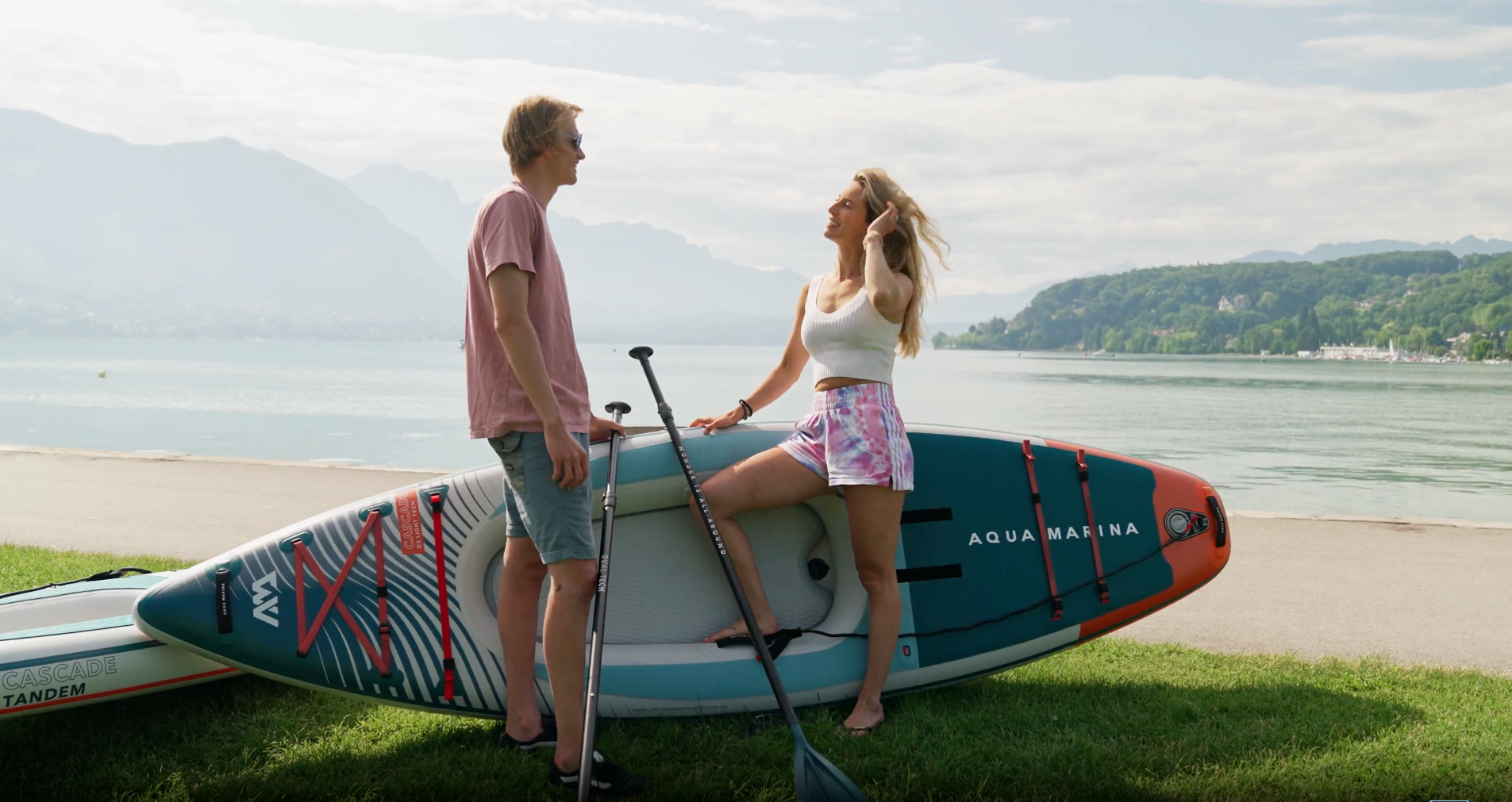 Two people standing by Aqua Marina Cascade 2-in-1 inflatable Kayak and iSUP Hybrid. Available in Models GT24CAP 11'2 x 35" and 13'2" x 39"