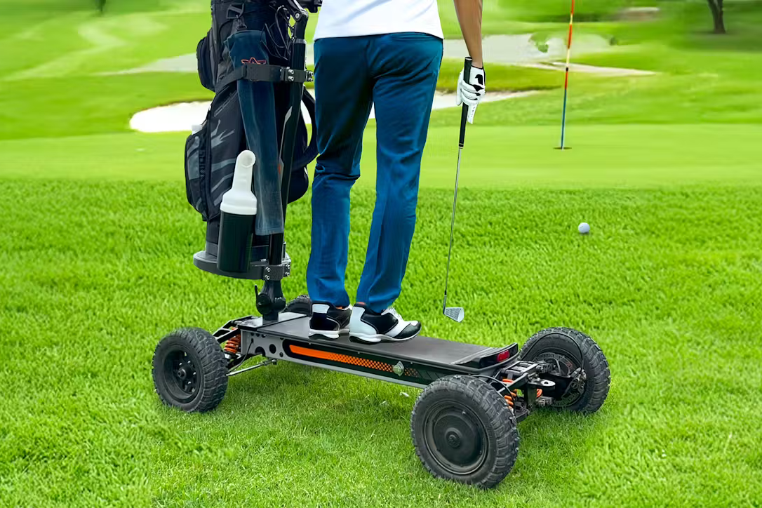 Golfer standing on CycleBoard X-Quad 3000 electric 4-wheel trail and fairway ride holding chipping wedge next to a golfing green. Free shipping at e-boarders.com