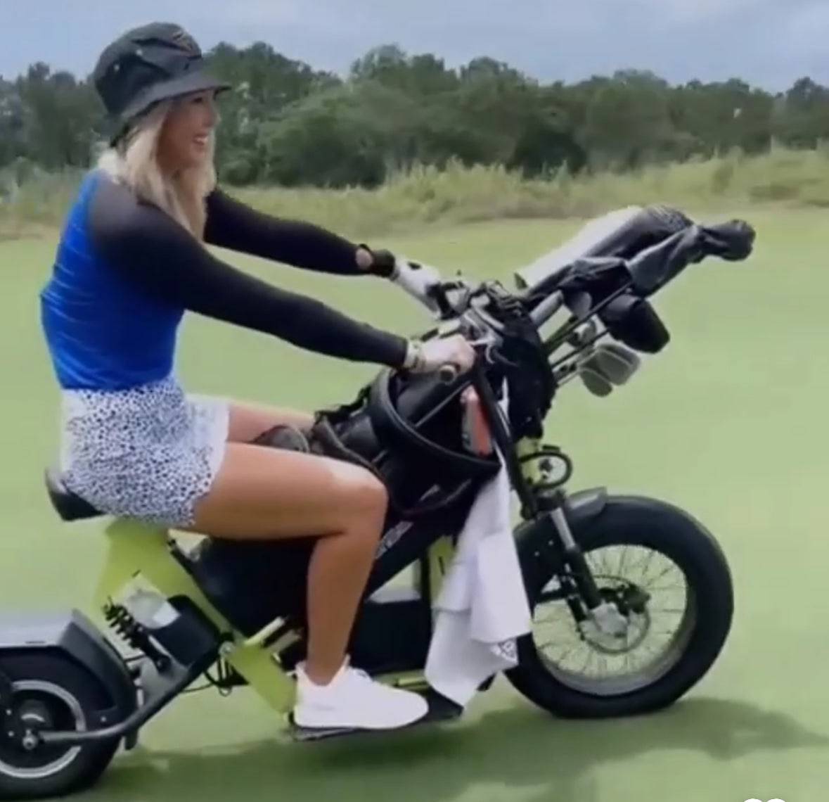 Female golfer riding Eahora M6G Electric golf caddy with golf clubs. Free shipping at E-Boarders.com