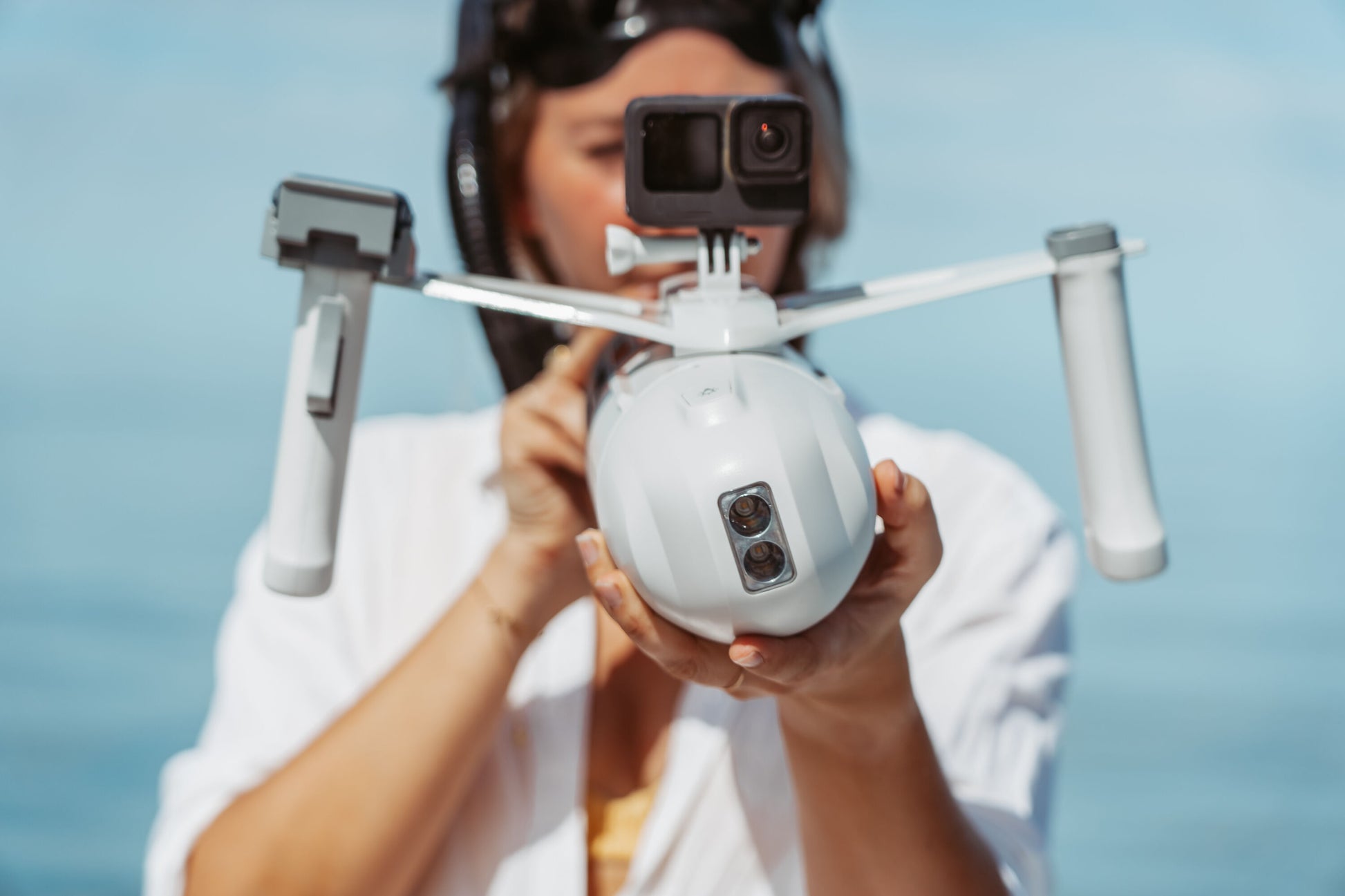 Person holding Aqua Marina Bluedrive X Pro compatible with standard GoPro camera mounts for underwater filming. Available with free shipping at E-Boarders.com