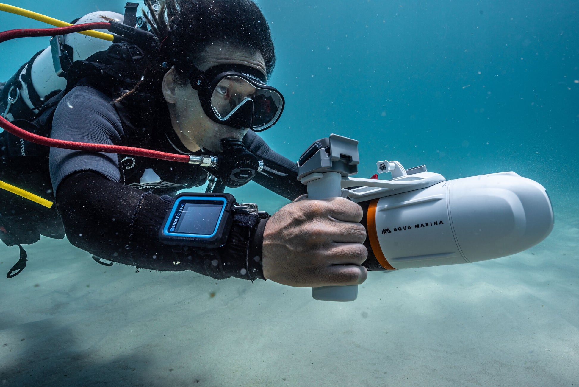 Diver with Aqua Marina BLUEDRIVE X Pro electric-assist fin system for paddleboards, kayaks, and surface swimming. Includes wireless remote control and rechargeable battery. Free shipping at e-boarders.com