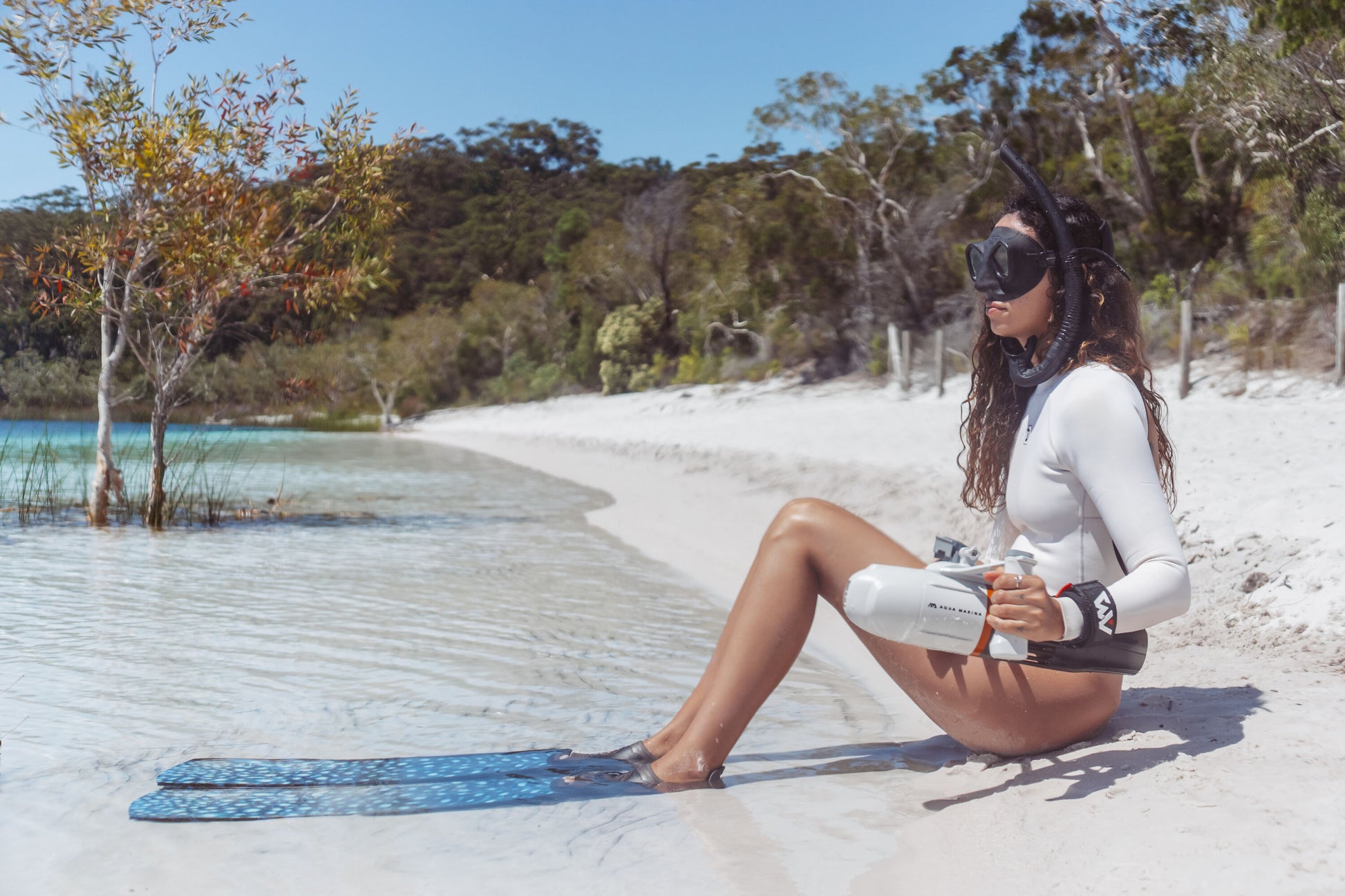 Woman on beach with snorkel gear holding Aqua Marina BLUEDRIVE X Pro Free shipping at e-boarders.com