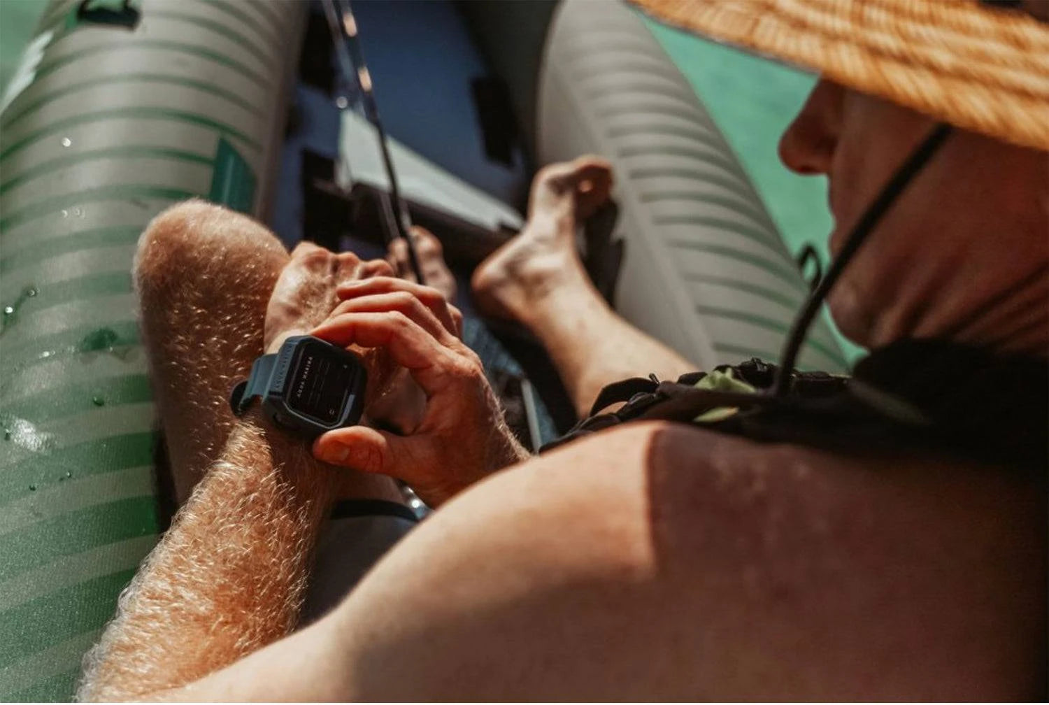 Kayak angler fisherman adjusting wireless wrist-watch remote for Aqua Marina BLUEDRIVE X Pro. Free shipping at e-boarders.com
