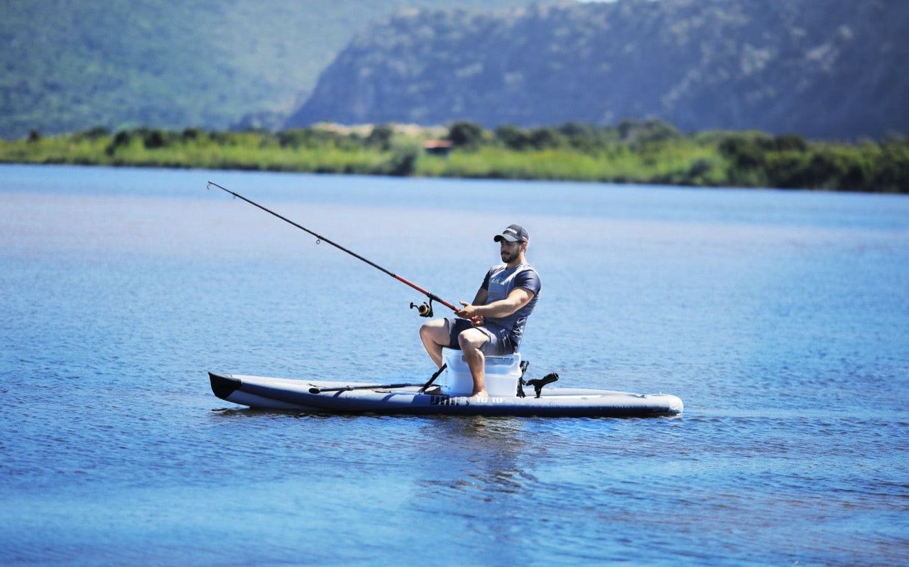 Lifestyle photo man casting a fishing rod line on Aqua Marina Drift iSUP with rod holder — ships free at e-boarders.com