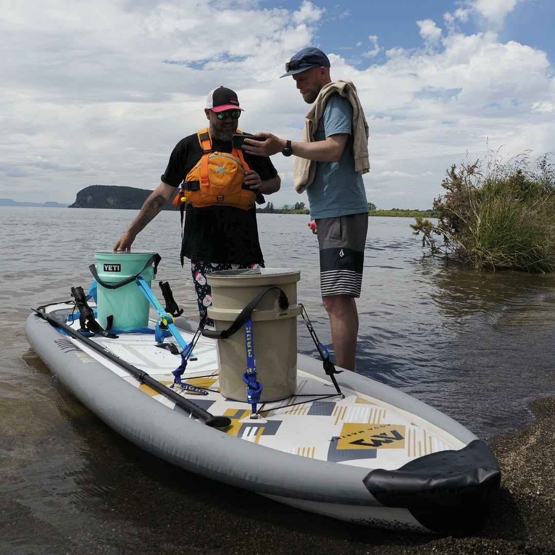 Men standing with Aqua Marina Drift iSUP with rod holder — ships free at e-boarders.com