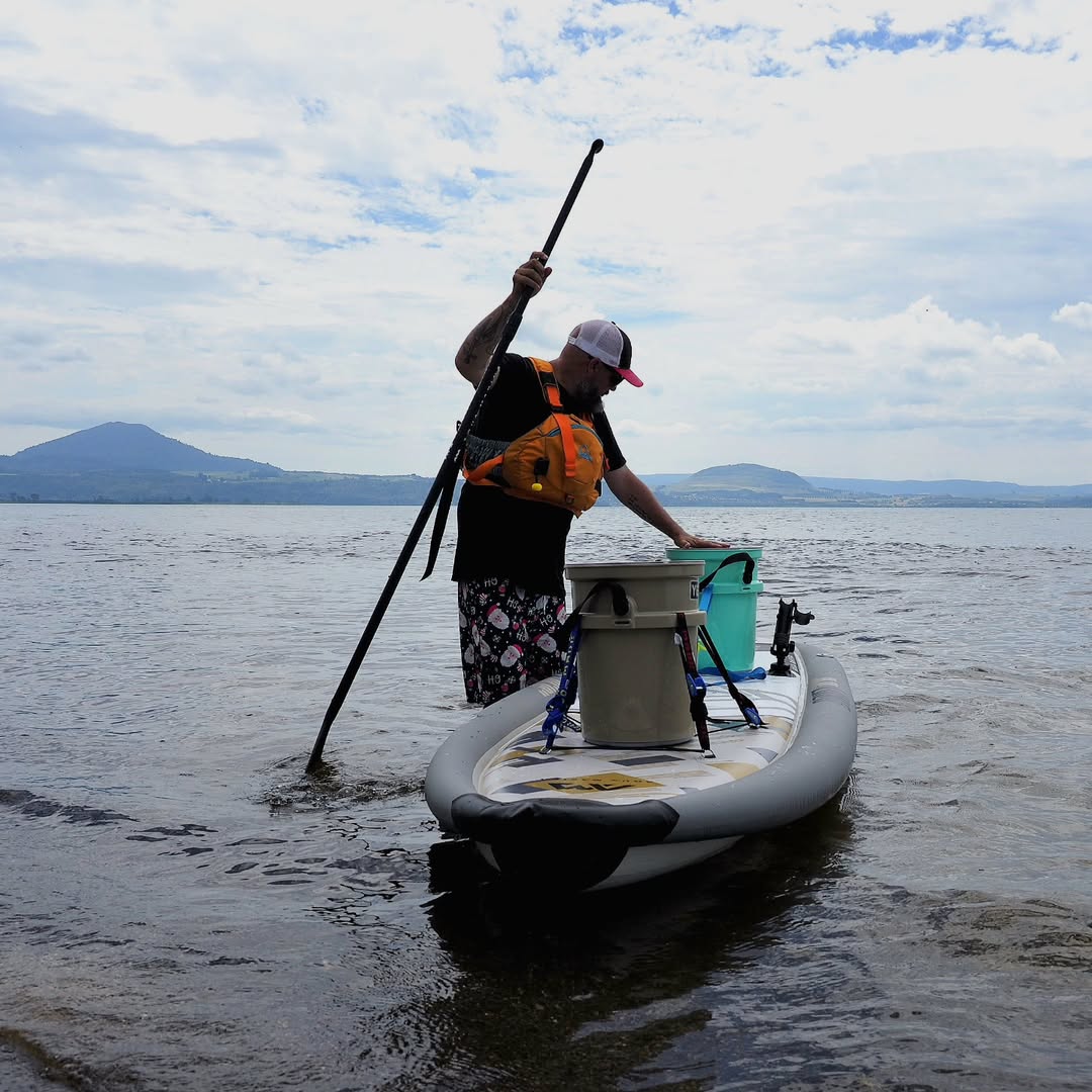 Lifestyle photo man paddling on Aqua Marina Drift iSUP with rod holder — ships free at e-boarders.com