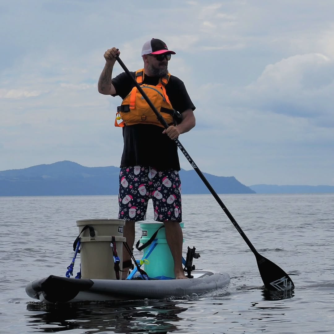 Lifestyle photo man stand up paddling on Aqua Marina Drift iSUP with rod holder — ships free at e-boarders.com