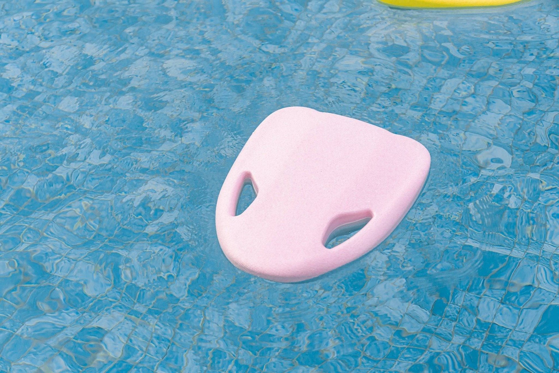 ASIWO MAKO electric swimming kickboard in pink floating in a pool for aquatic swim assistance. Ships free at e-boarders.com