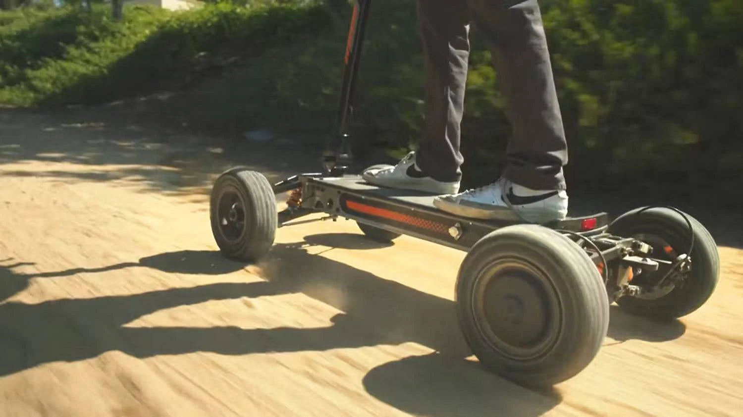 Man riding Cycleboard X-Quad 3000 with recreational all-terrain 13x4" fat tire treads, on dirt path. Free shipping at e-boarders.com