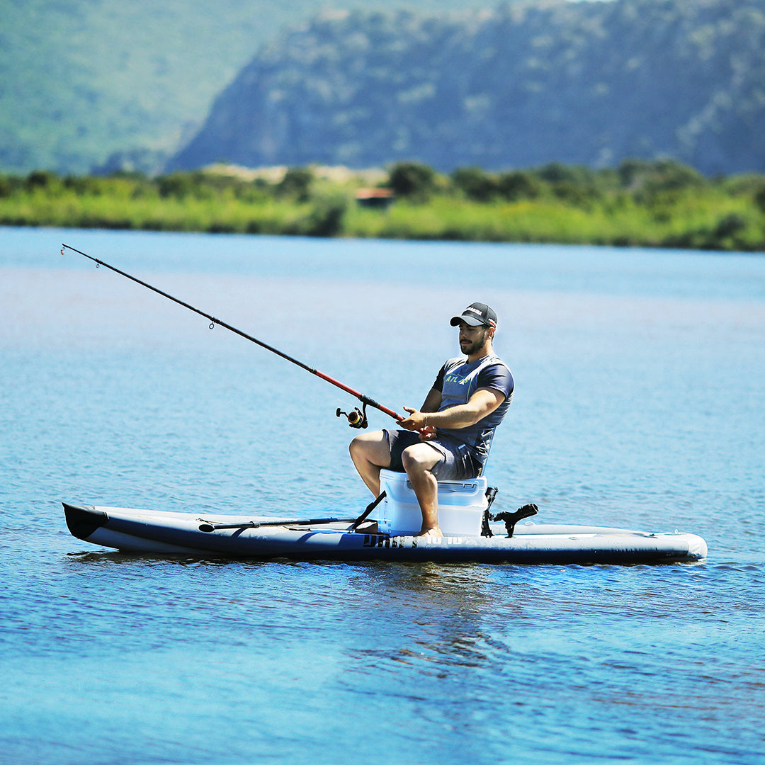 Lifestyle photo man sitting on cooler on Aqua Marina Drift iSUP with rod holder — ships free at e-boarders.com