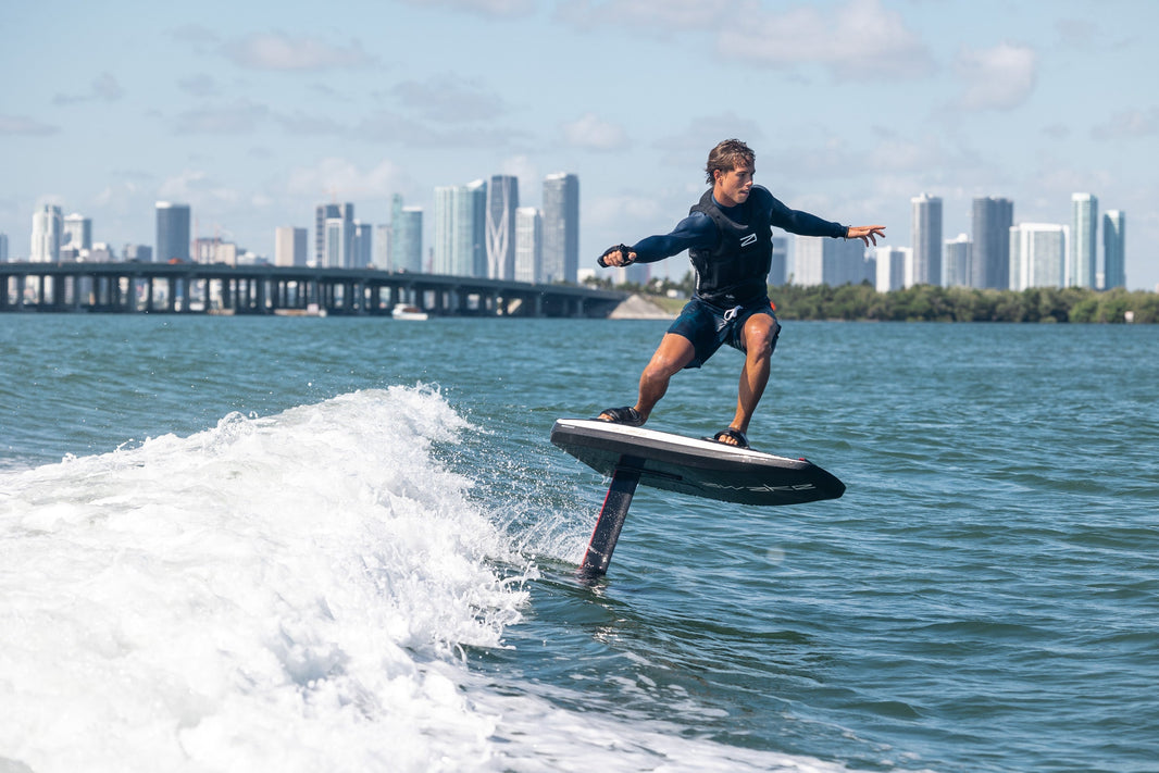 Man surfs on electric wakeboard efoil by Awake Vinga 3 or Vinga S EFoil. 