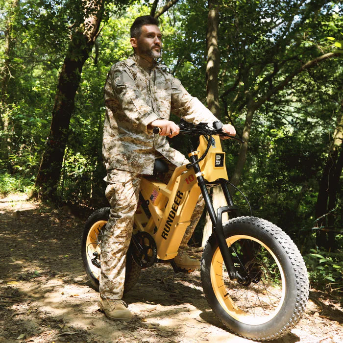 Rundeer Electric Mountain eBike with fat tires and man in camo gear riding off-road. Available at E-Boarders.com