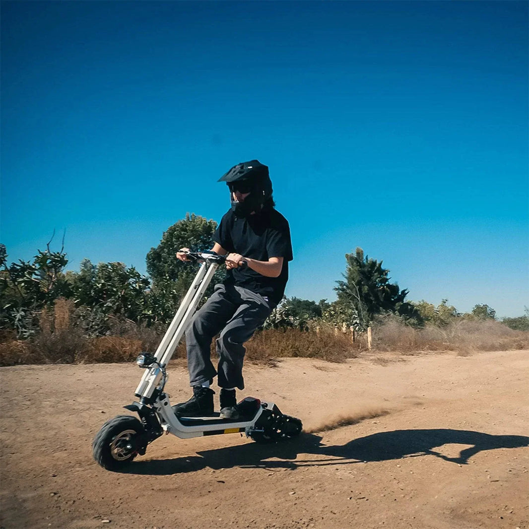 Man rides Phantom GoGo G63 Electric E-Scooter for Dirt, Snow, Street, Off-Road, Communiting. Offered at E-Boarders.